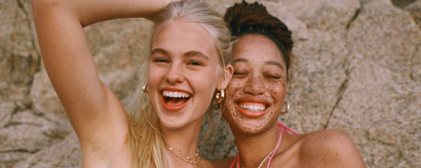 Two friends smile widely