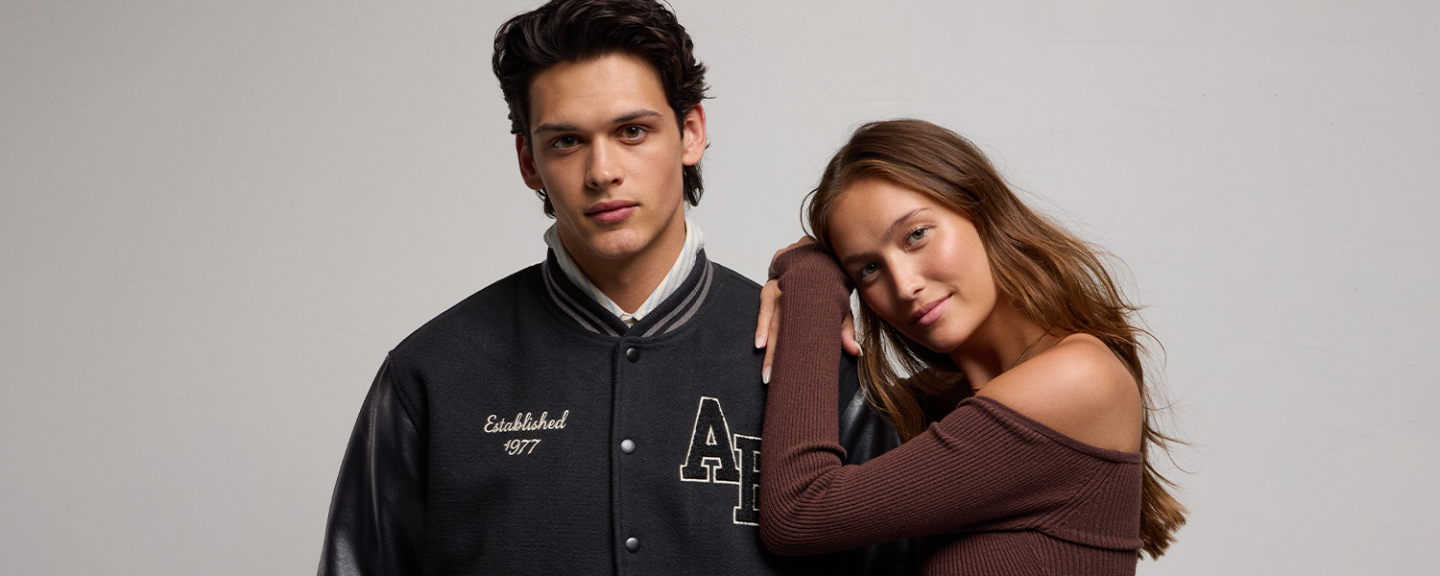 A young woman leans on against a young man's shoulder