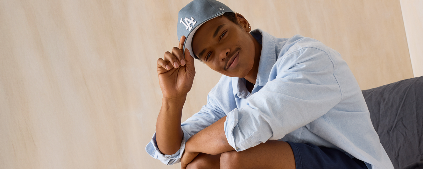 a young black man smiles at the camera