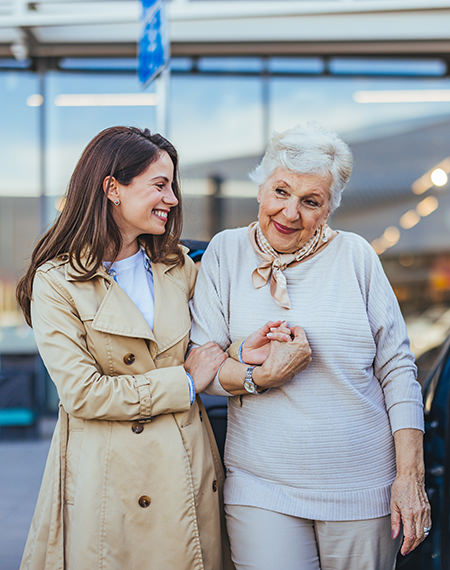 Young woman assisting her elderly mother