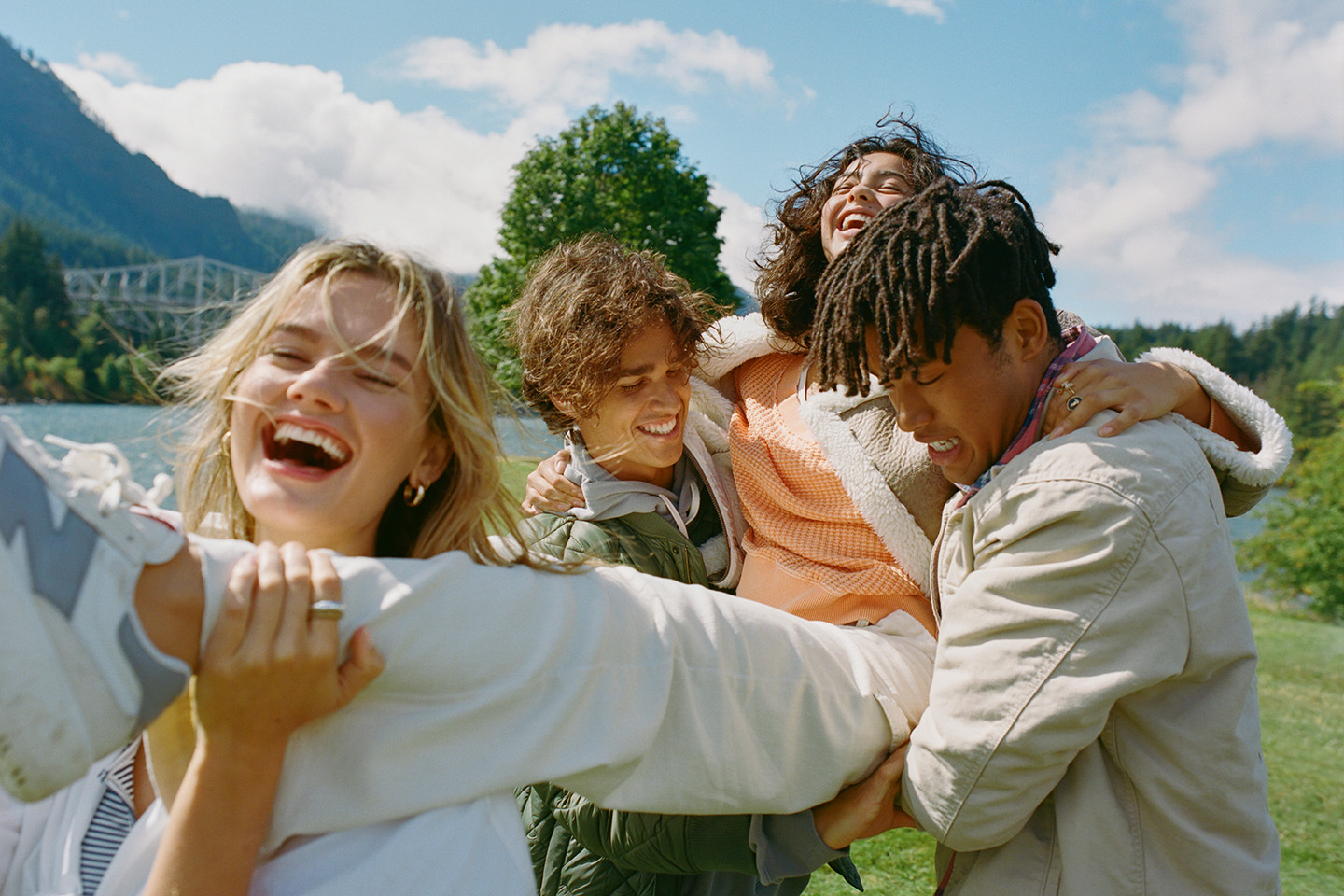 A group of friends laugh while outside